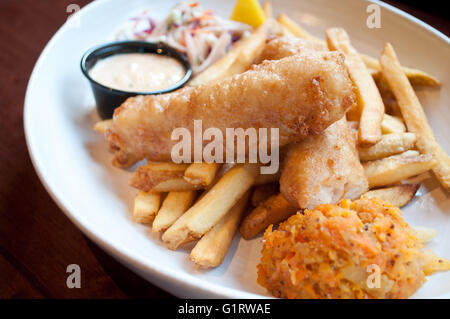 A beautiful prepared fish and chips platter, complete with coleslaw, clapshot and homemade tartar sauce. Stock Photo