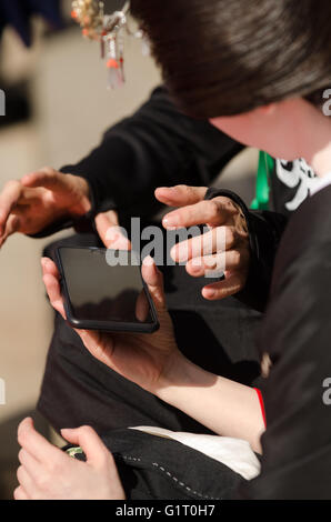 Two friends with smart phone outdoor looking at device Stock Photo