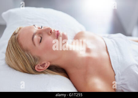 Close up of attractive woman at dayspa. She is lying on massage table. Beauty and health concept. Stock Photo