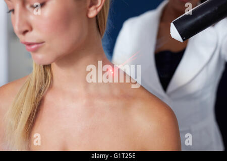 Closeup of localized cryotherapy session to the neck of young woman. Ice cold nitrogen vapors applied to neck Stock Photo