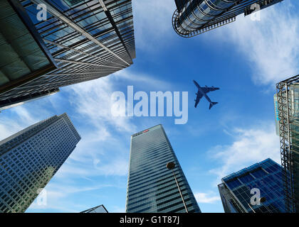 Airplane Flying Over Canary Wharf, London, England, UK Stock Photo
