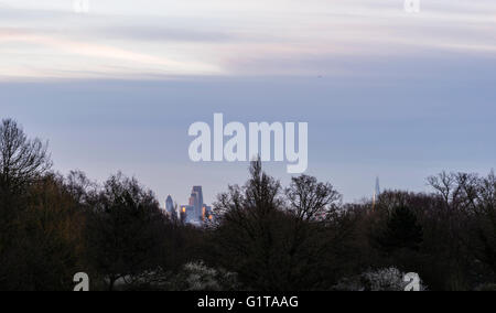 Golden reflections captured from Hampstead Heath at dawn in the buildings of the London skyline, UK.
