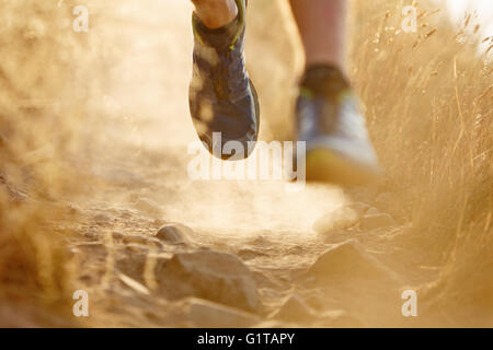 Close up of runner’s feet on dirt trail Stock Photo