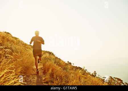 Man running on sunset trail Stock Photo
