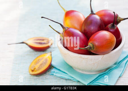 Tamarillo fruits with slice on blue napkin Stock Photo