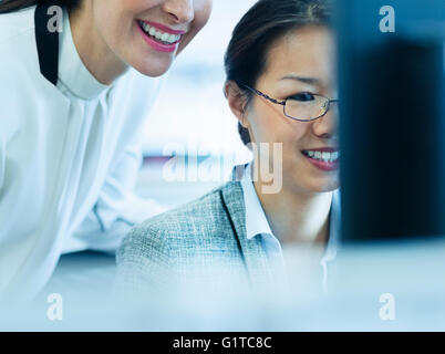 Smiling businesswomen working at computer in office Stock Photo