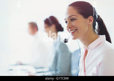 Smiling businesswoman talking on the phone with headset Stock Photo