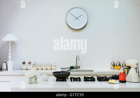 Modern clock on wall in kitchen Stock Photo