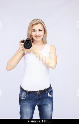 Happy woman holding camera Stock Photo