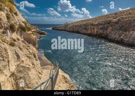 Rocky cliffs in Malta hiding many beautiful places Stock Photo