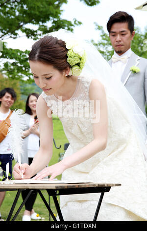 Japanese bride signing wedding certificate