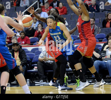 Washington, DC, USA. 18th May, 2016. 20160518 - Dallas Wings forward AERIAL POWERS (23) dishes the ball off to a teammate while under pressure from Washington Mystics center KIA VAUGHN (9), right, and Washington Mystics forward KAHLEAH COPPER (2), back, in the second half at the Verizon Center in Washington. © Chuck Myers/ZUMA Wire/Alamy Live News Stock Photo