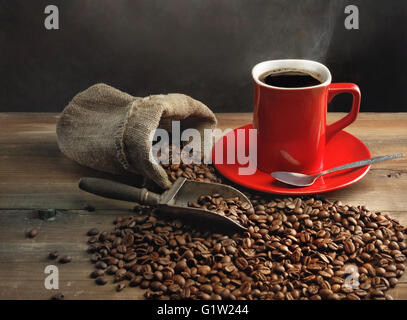 Coffee cup and coffee beans on wooden table Stock Photo
