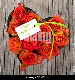 Heart of roses on wooden background Stock Photo