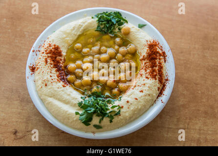 Hummus with olive oil, parsley and beans Stock Photo