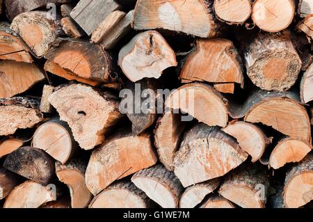 Stack of chopped firewoods prepared for winter. Background Stock Photo