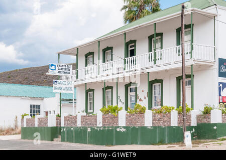 UNIONDALE, SOUTH AFRICA - MARCH 5, 2016: A storm brewing over a guesthouse an liquor store in Uniondale in the Western Cape Stock Photo