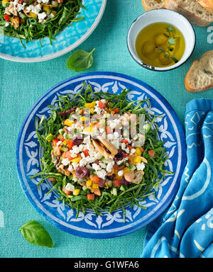 A delicious mediterranean mussel salad with chopped spinach, red pepper, yellow pepper, cucumber, kalamata olives, and feta chee Stock Photo