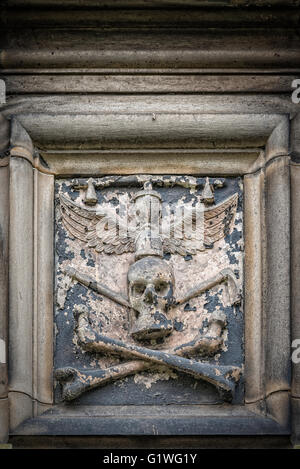 Stone skull relief on Glasgow cathedral in Scotland. Stock Photo