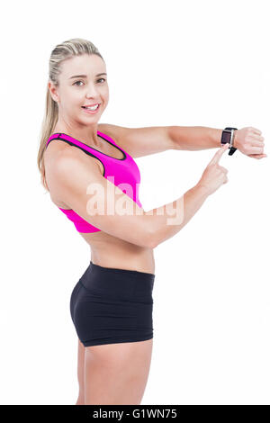 Female athlete using her smart watch Stock Photo