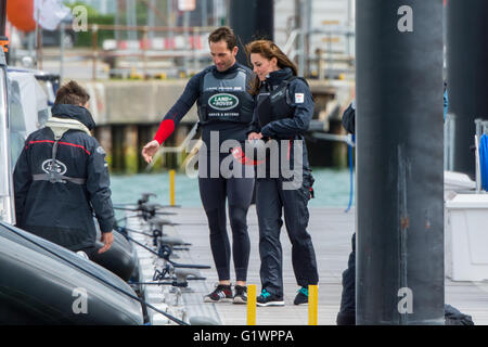 Sir Ben Ainslie guides The Duchess of Cambridge to a waiting boat at the BAR HQ at Portsmouth, UK on the 20th May 2016. Stock Photo