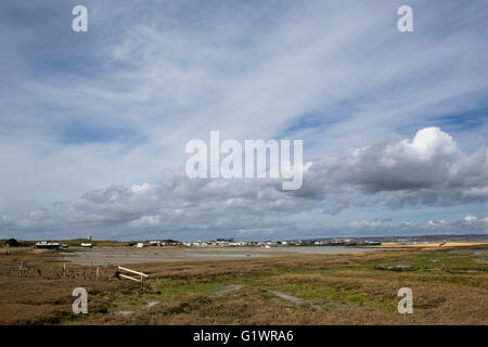 Waterfront living in West Hayling. Boat houses and holiday homes on the beach. Mixed sky on a great spring day Stock Photo