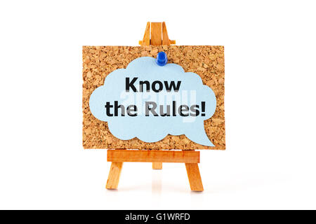 Wooden easel with cork board and blue speech bubble with words Know the Rules! on white background Stock Photo