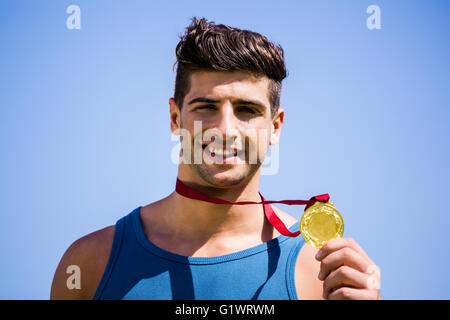 Athlete showing his gold medal Stock Photo