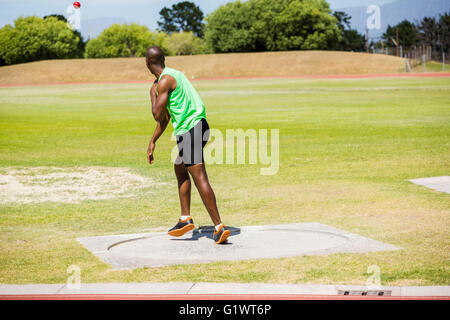 Male athlete throwing shot put ball Stock Photo