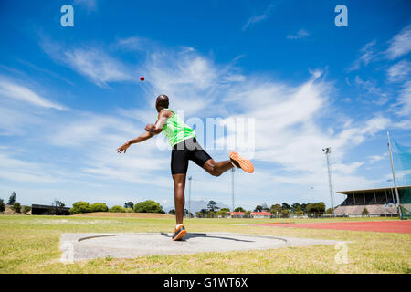 Male athlete throwing shot put ball Stock Photo