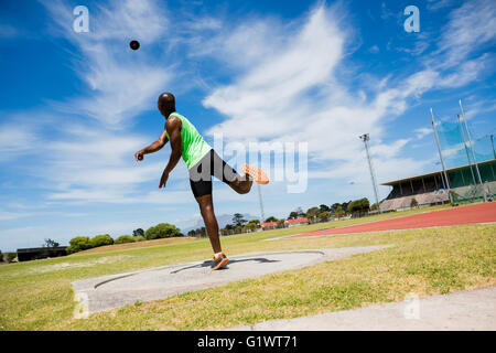 Male athlete throwing shot put ball Stock Photo