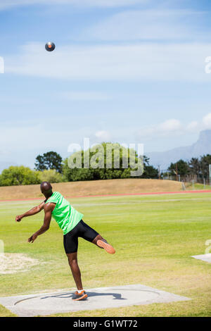 Male athlete throwing shot put ball Stock Photo