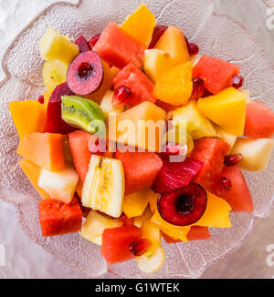 mixed fruit salad, water melon, mango, rock melon, honey melon, apple, pear, kiwi, cherry, plum, banana, grape, pomegranate Stock Photo