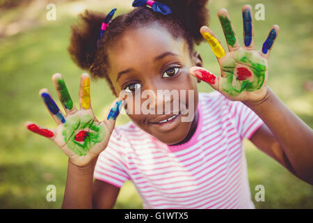 Little girl showing her painted hands to the camera Stock Photo