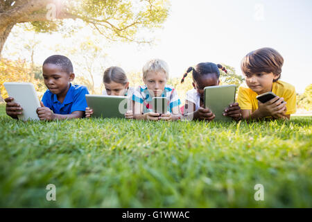 Kids using technology during a sunny day Stock Photo