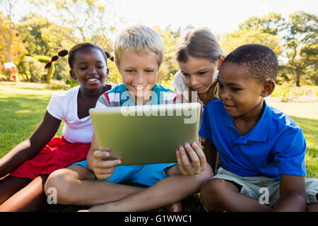 Kids using technology during a sunny day Stock Photo