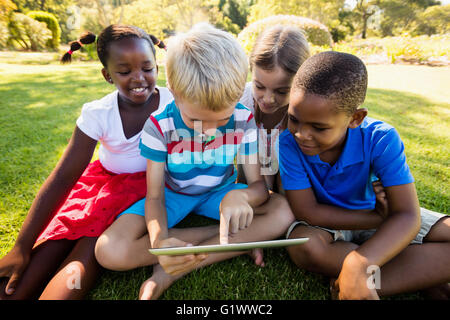 Kids using technology during a sunny day Stock Photo