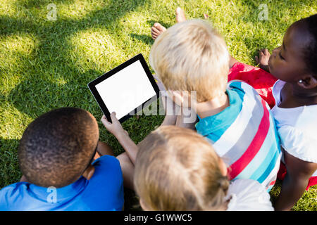 Kids using technology during a sunny day Stock Photo