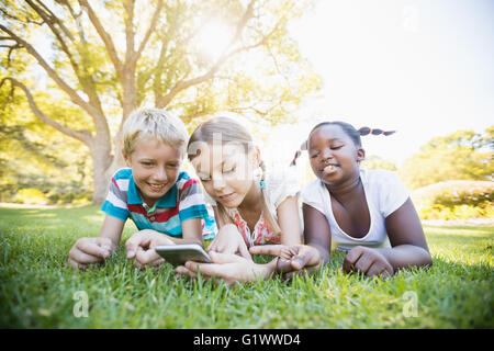 Kids using technology during a sunny day Stock Photo