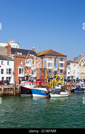 Colourful fishing boats moored alongside the quay on the River Wey in Weymouth harbour, Dorset, England, UK Stock Photo