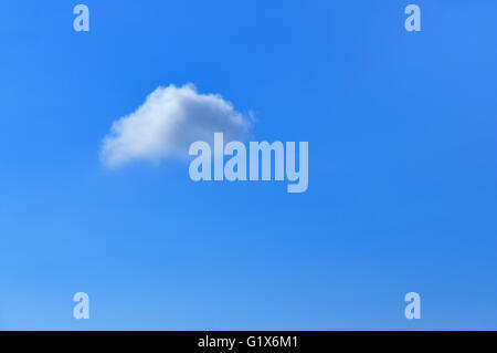 Single small cloud in the blue sky, Lower Saxony, Germany Stock Photo