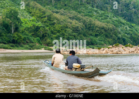 Local fishermen with narrow motor boat on the Mekong, Louangphabang Province, Laos Stock Photo