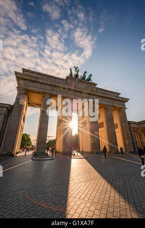 Evening sun shining through Brandenburg Gate in Berlin Germany Stock Photo