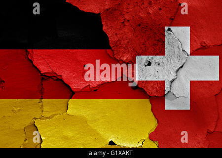 flags of Germany and Switzerland painted on cracked wall Stock Photo