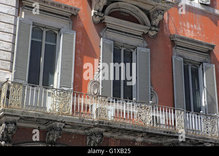 Ornate balcony and shutters around the windows, typical of buildings in Rome, Italy Stock Photo