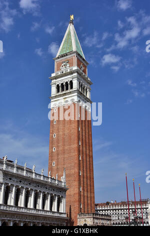 Saint Mark bell tower, the tallest belfry in Venice and one of the city landmark, with old National Library Stock Photo