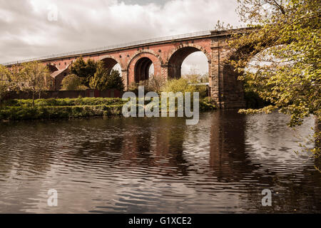 A scenic view of the River Tees at Yarm  showing the rail viaduct and tree lined river banks Stock Photo