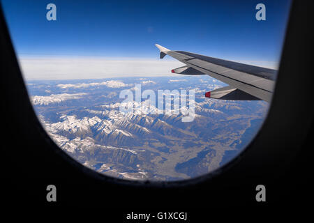 Airplane flying over the Alps, Europe Stock Photo