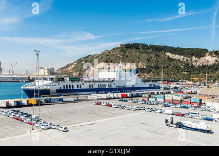 Containers and cars parked in a row waiting to board at the port of Barcelona, Catalonia, Spain Stock Photo