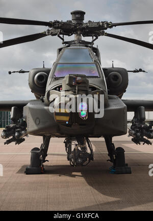 Boeing AH-64 Apache helicopter at rest on airfield apron Stock Photo